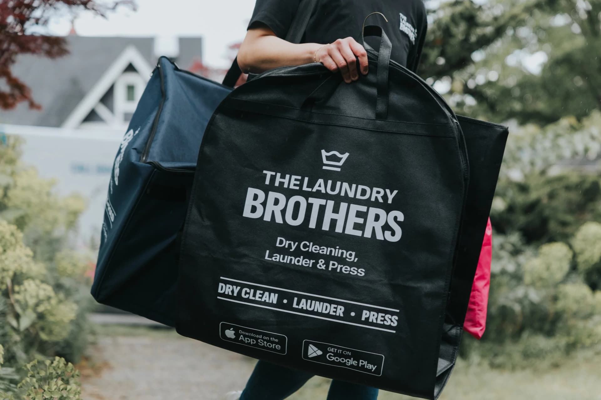 Pressed garments on hangers, dry cleaned by The Laundry Brothers.